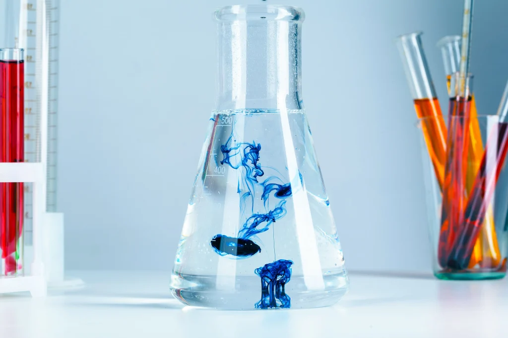 Laboratory flasks and glassware with reflections on table surface for Hydrolyz water analysis lab